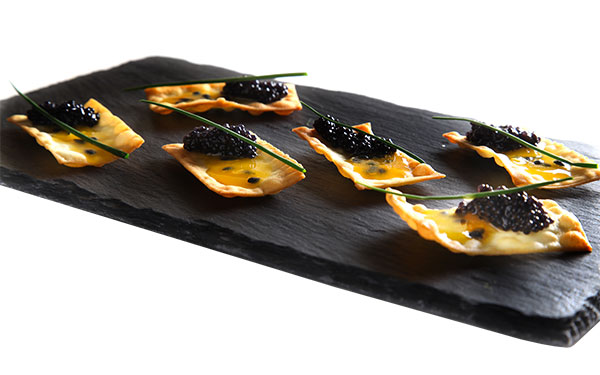 Crackers with lumpfish roe, passion fruit, and Sicilia PGI Extra Virgin Olive Oil 1
